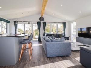 a kitchen and living room with a couch and a table at 20 Meadow Retreat in Liskeard