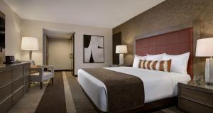 a hotel room with a large bed and a chair at Santa Fe Station Hotel & Casino in Las Vegas +37 photos