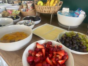 a table with bowls of fruits and vegetables on it at Marlborough Hotel in Shanklin