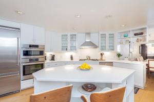 a kitchen with white cabinets and a white island at Ice House 317 condo in Telluride