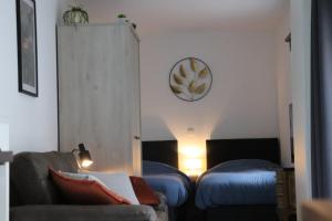 a living room with a couch and two beds at Happy Homes Melle Centre, Near Ghent! in Melle