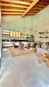 a living room with a table and chairs and a kitchen at Residencial Buritis-Tarumã Hípica Park in Bonito