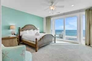 a bedroom with a bed and a view of the ocean at Valhalla in St. George Island