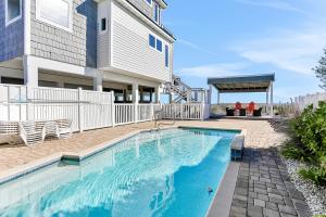 a swimming pool in front of a house at Valhalla in St. George Island