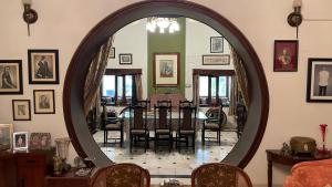 a dining room with a table and a mirror at Vijai Mahal - A Colonial Homestay in Ajmer