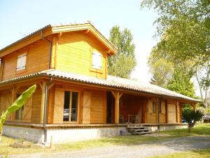 una casa de madera con techo de gambrel en La cle des champs, en Dax