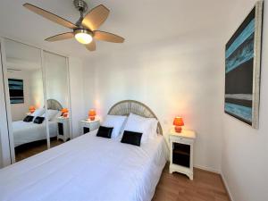 a bedroom with a white bed and a ceiling fan at Josephine in Dax