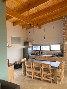 una cucina con un grande tavolo e sedie in legno di DieStrandwolf Sea View Self Catering a Hentiesbaai