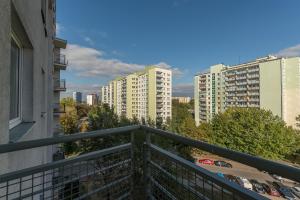 a balcony with a view of some buildings at Bielany P&O Apartments in Warsaw