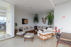 a living room with couches and chairs and a table at Faro Hotel Atibaia in Atibaia