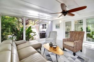 a living room with a couch and chairs and a ceiling fan at Wilton on the water courtyard and Heated Pool in Fort Lauderdale