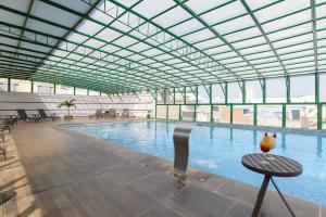 a large swimming pool with a large glass ceiling at Faro Hotel Atibaia in Atibaia
