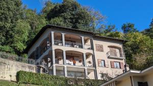 a large building with balconies and plants on it at Villa Le Arcate zona Lago Maggiore in Cittiglio
