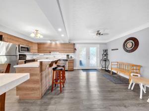 a kitchen with white walls and wooden cabinets at Park Bungalow - Seacliff Beach Suites in Leamington