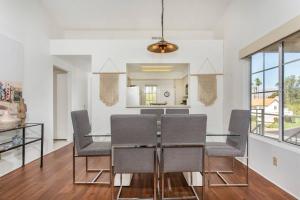 a dining room with a glass table and chairs at BEAUTIFUL Palm Desert OASIS 2bd 2ba GETAWAY in Palm Desert