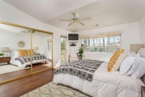 a bedroom with a large bed and a mirror at BEAUTIFUL Palm Desert OASIS 2bd 2ba GETAWAY in Palm Desert +29 photos