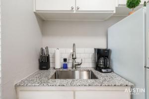 a kitchen counter with a sink in a kitchen at 1st Floor Apt Hyde Park Bathtub and Free Parking in Austin