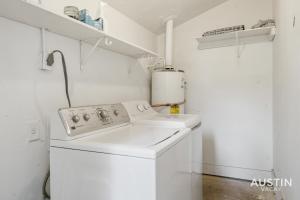 a white laundry room with a washer and dryer at Walk to Barton Springs Spacious Apt Backyard in Austin +20 photos
