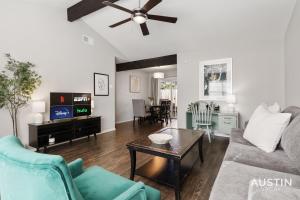 a living room with a couch and a table at Walk to Barton Springs Spacious Apt Backyard in Austin