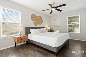 a bedroom with a bed and a ceiling fan at Walk to Barton Springs Spacious Apt Backyard in Austin