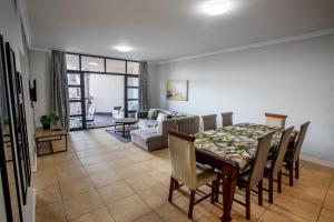 a living room with a table and a couch at Stay at the Point - Harbour Haven in Durban