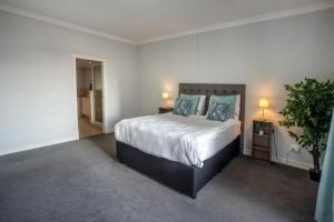 a bedroom with a large bed and a potted plant at Stay at the Point - Harbour Haven in Durban