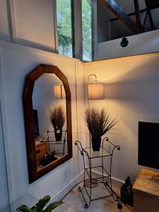 a room with a mirror and a chair and a tv at Huge Peaceful beamed Sanctuary ! in St. Albans