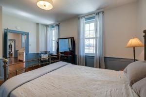 a bedroom with a large bed and a window at Historic Raphine Retreat Near Brownsburg Village! in Raphine