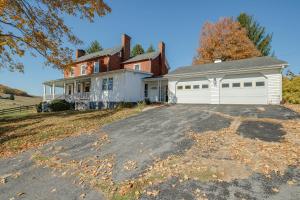 a house with a driveway in front of it at Historic Raphine Retreat Near Brownsburg Village! in Raphine