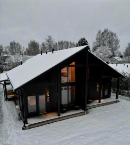 a house with a roof covered in snow at Luxury Villa Lapland in Rovaniemi