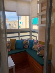 a couch sitting in a room with a large window at Apartamento Parquesol in Antequera