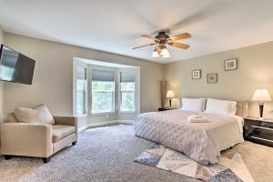 a bedroom with a ceiling fan and a bed and a chair at Spacious Parkview Home Near Denver with Game Room in Thornton