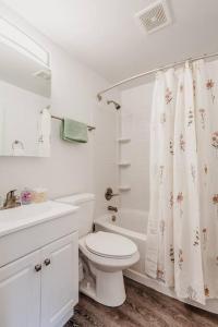 a white bathroom with a toilet and a shower at Cozy, Central 1B Apt Close to UC Hospitals, DT in Bellevue