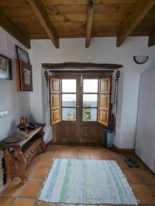 a living room with a door and a rug at Casa Maricolilla in Cortelazor