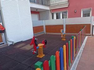 un patio trasero con una valla y un patio de juguetes en EnFOZ PLAYA PISCINA Y PARKING, en Foz