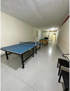 a room with two ping pong tables in it at AP Aconchegante a 60 Metros da Praia, vista mar 302 in Praia Grande +3 photos