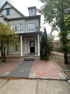 a house with a brick driveway in front of it at Cozy-2bedroom in Oakville in Oakville