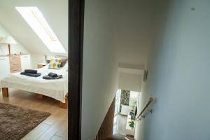 a bedroom with a bed and a window at Ciao Lilla Apartman in Keszthely