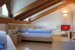 a bedroom with a large bed with blue pillows at Manzoni Rooms in Merano