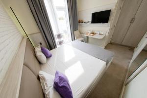 a small room with a bed and a window at Zimmer Boutique Hotel in Baku