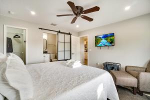 a bedroom with a white bed and a ceiling fan at Family-Friendly Home in Casselberry with Fire Pit! in Orlando