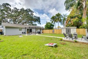 a backyard with chairs and a table in the grass at Family-Friendly Home in Casselberry with Fire Pit! in Orlando