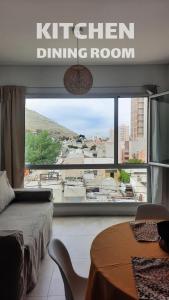 a bedroom with a bed and a large window at DEPARTAMENTO FRANCIA centrico 1 dor in Comodoro Rivadavia