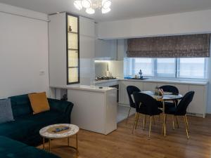 a living room with a couch and a table and a kitchen at Casa Boes 41 in Vişan