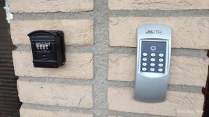 a remote control attached to the side of a brick wall at Villa Homestay Nad Helmrovkou in Prague