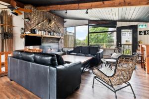 a living room with couches and a table and chairs at Semi Detached Mountain View Chalet in Blue Mountains