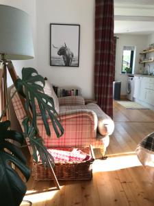 a living room with a couch and an animal picture on the wall at City Central Quiet Garden Studio with Free Parking in Inverness