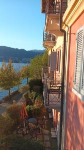 a balcony of a building with a table and chairs at Lake view rooms and flats Casa Sul Lago in Orta San Giulio