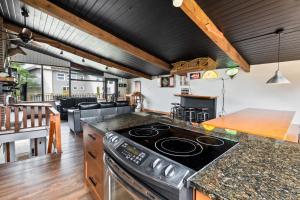 a kitchen with a stove top oven in a room at Semi Detached Mountain View Chalet in Blue Mountains