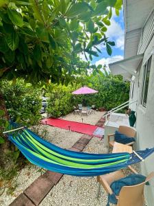 a hammock sitting on the side of a house at Nice Queen Bedroom - Best Location in Miami - Luggage Storage Service, Parking and Laundry for free!!!! in Miami